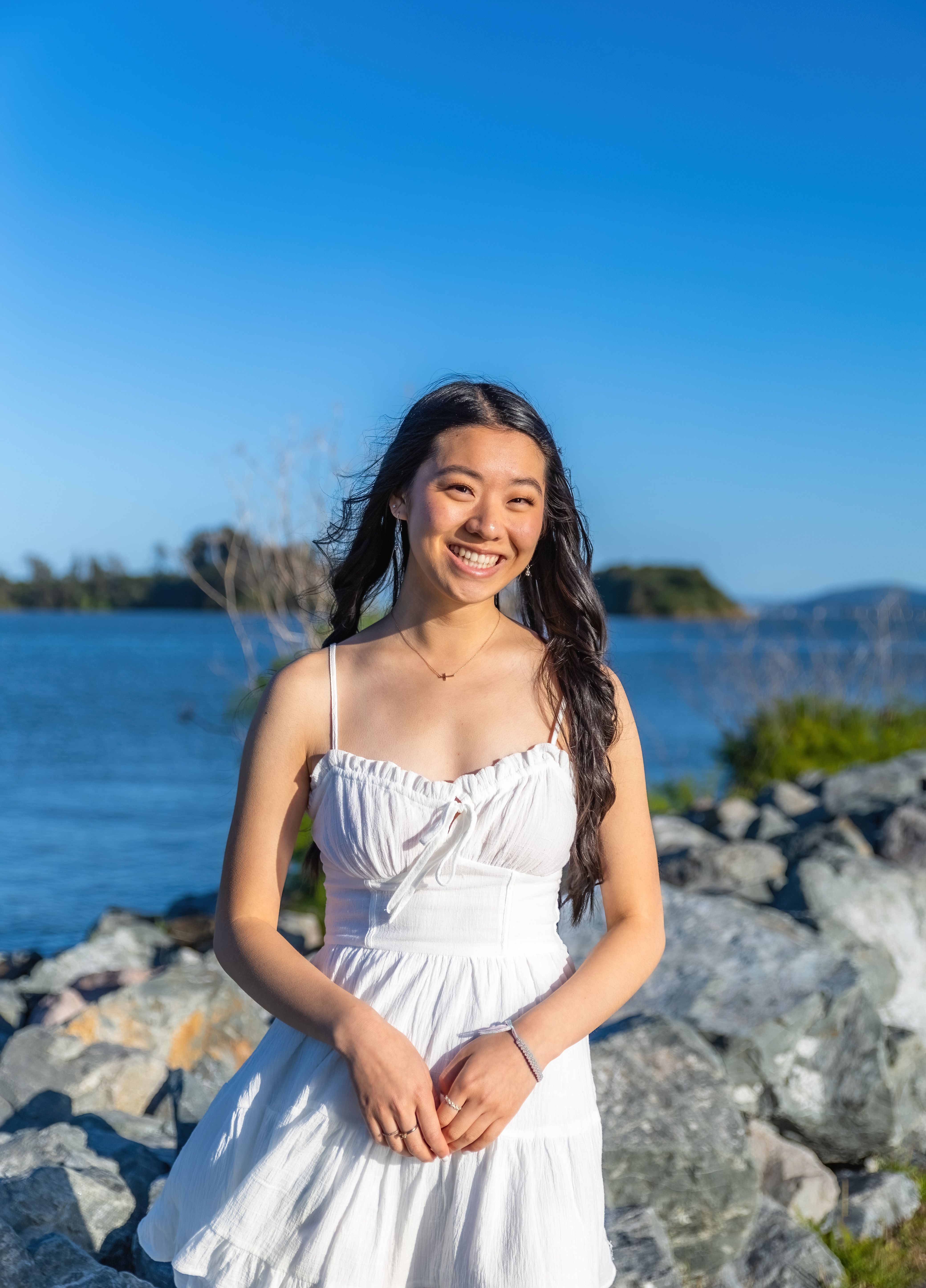 Young Woman in a White Dress Standing Outdoors and Smiling · Free Stock ...