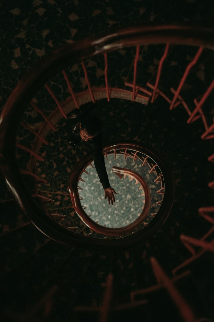 Top View Of Man Standing On Spiral Stairs 