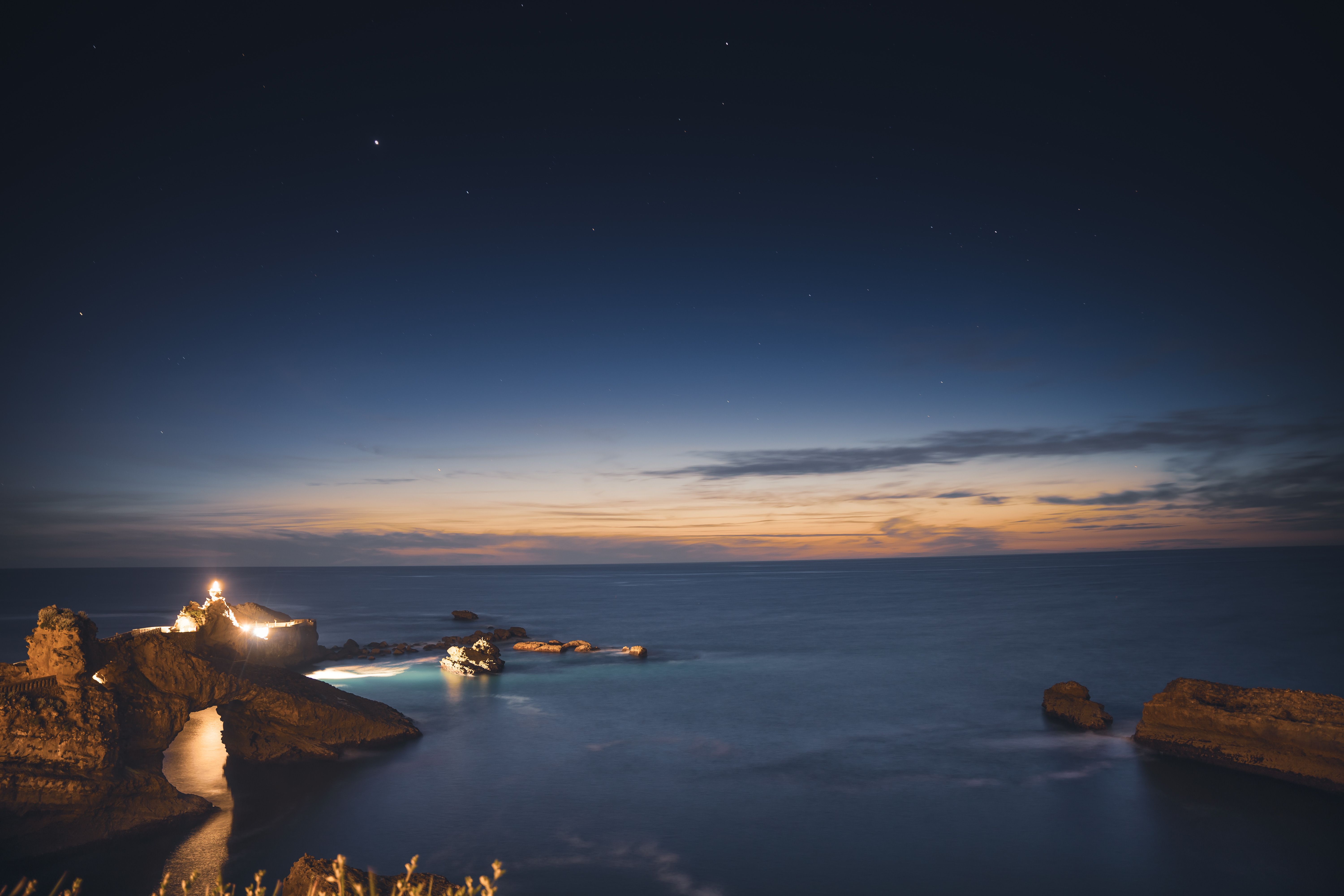 lighthouse beam night coastline