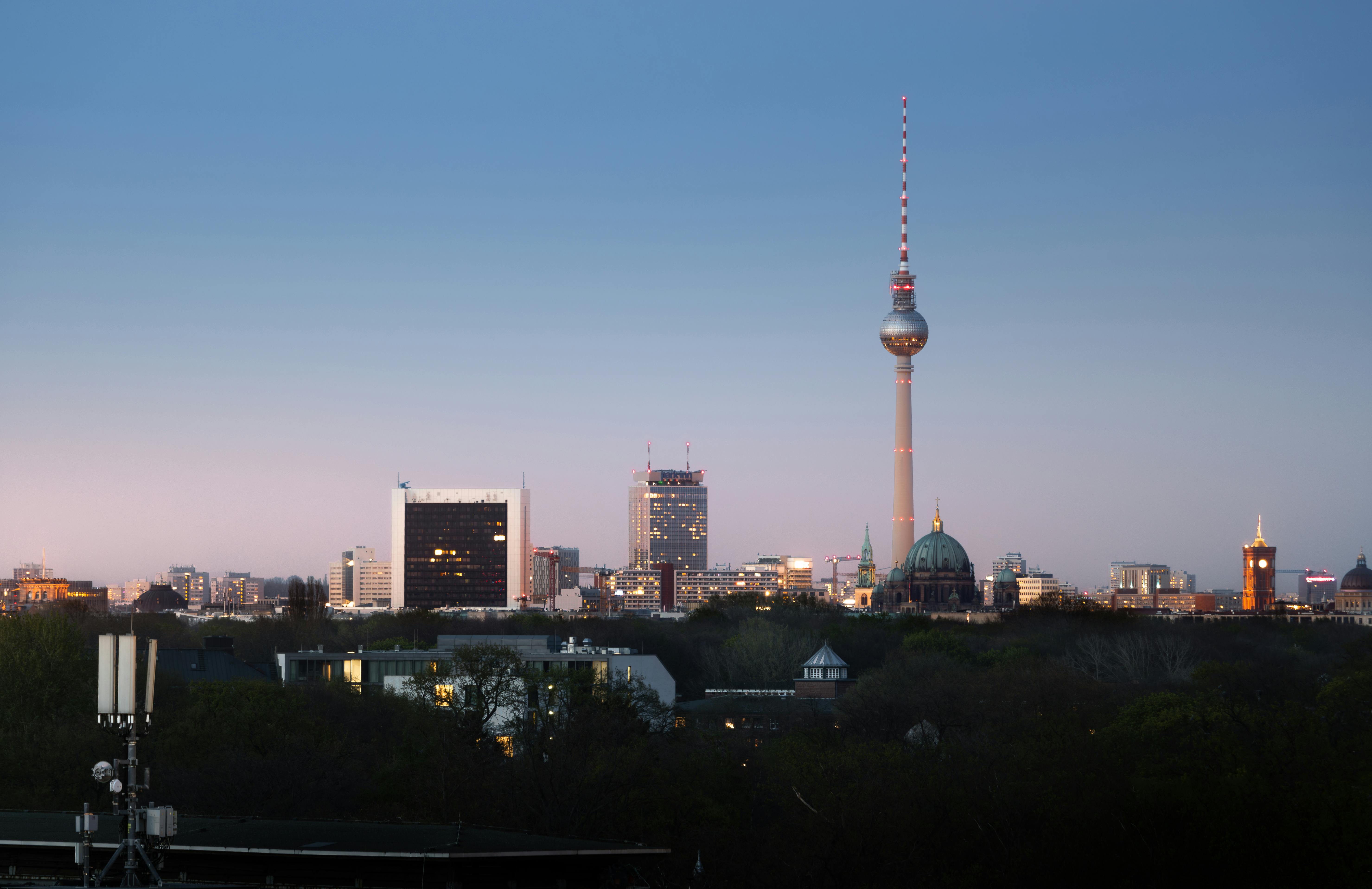 Satellite dish on rooftop against a clear blue sky