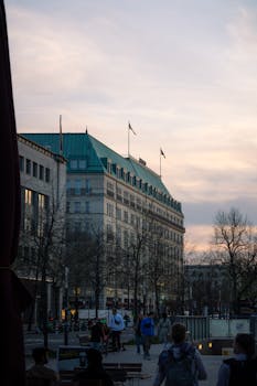 A bustling Berlin street scene featuring architecture, people, and sunset lighting.