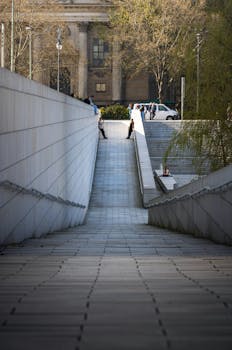 Contemporary Berlin staircase with urban scenery and people in spring.