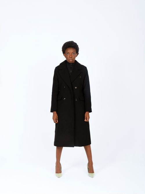 Free Stylish young woman in black coat posing in a studio setting. Perfect for fashion themes. Stock Photo