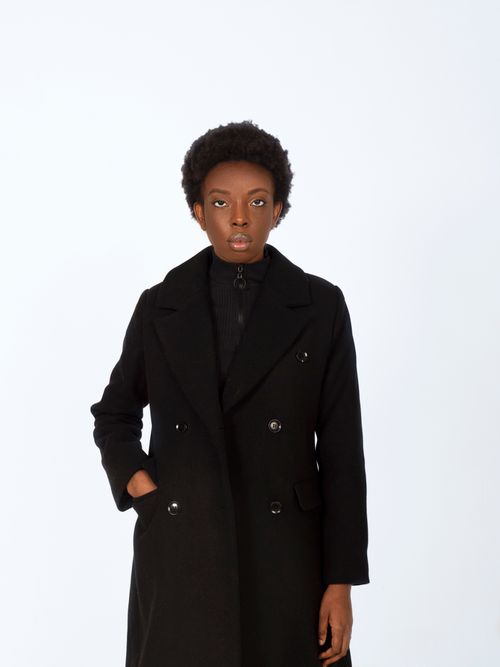 Free Stylish portrait of a woman in a black coat on a white background. Stock Photo