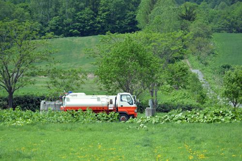 Water Delivery & Sale Management System — Water tank truck delivering water in a rural setting