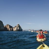 Kayakers beside ocean cliffs — photo by Ricky Esquivel on Pexels