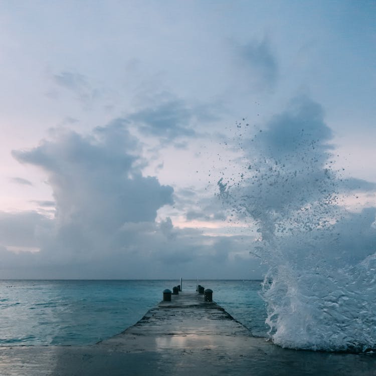 Ocean Wave Splashing On Dock