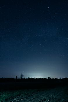 Capture of a serene rural night sky filled with stars, offering a glimpse of the cosmos.