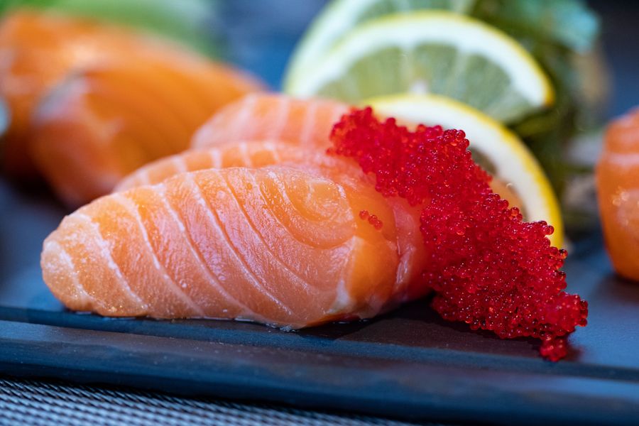 Fresh salmon fillets with citrus and roe on the slab