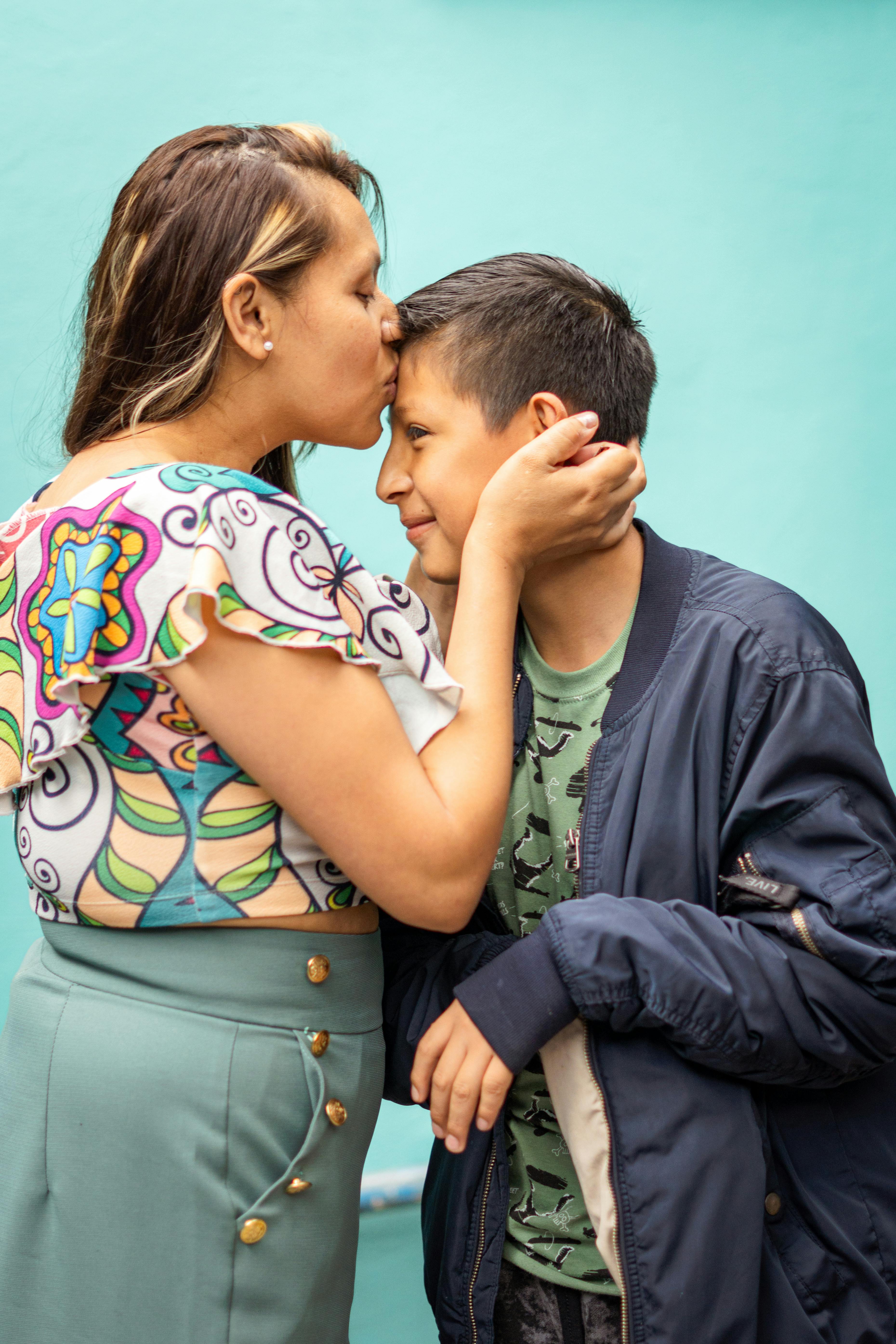 Mom Kissing Her Son on the Cheek · Free Stock Photo