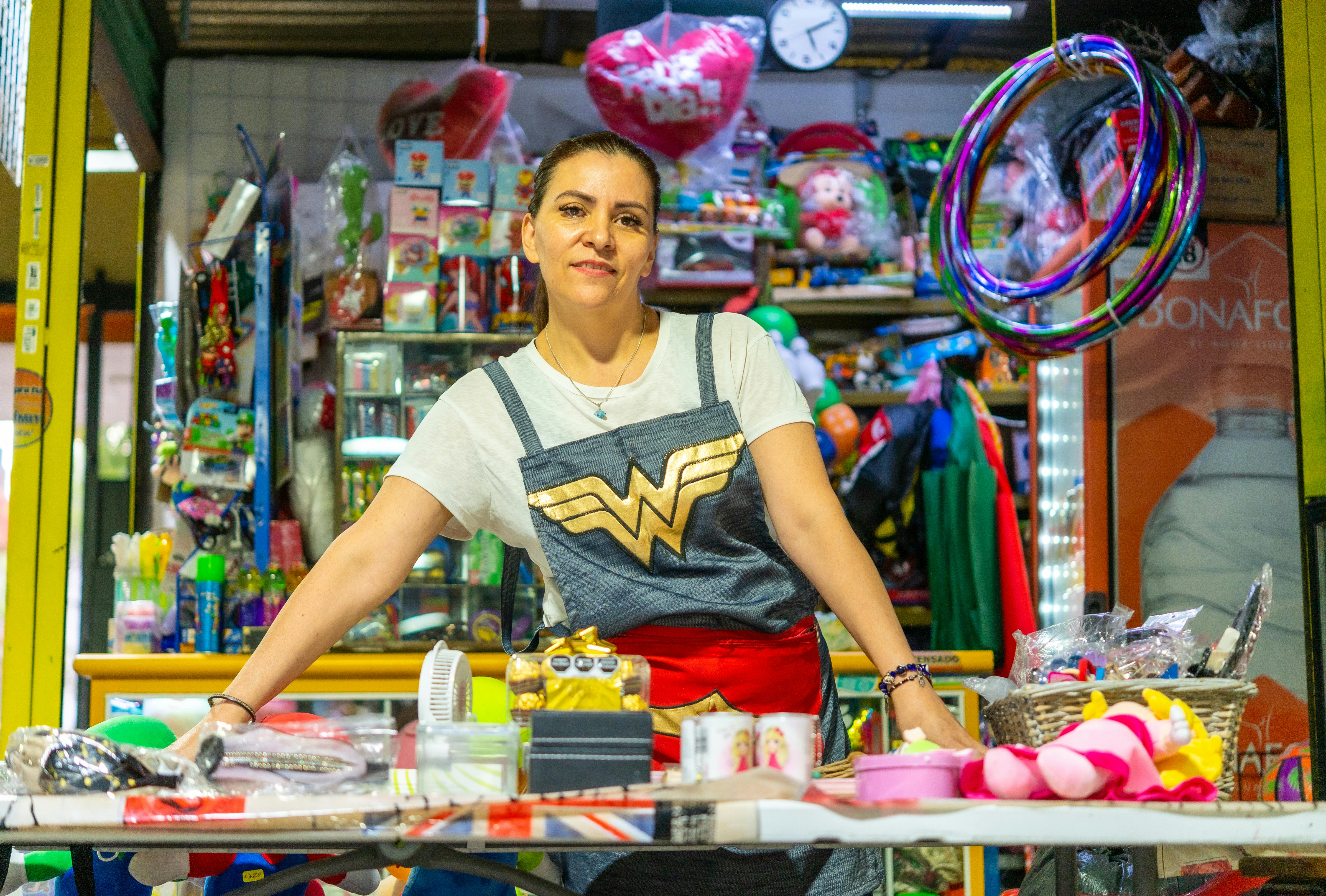 a woman in a costume standing in front of a table