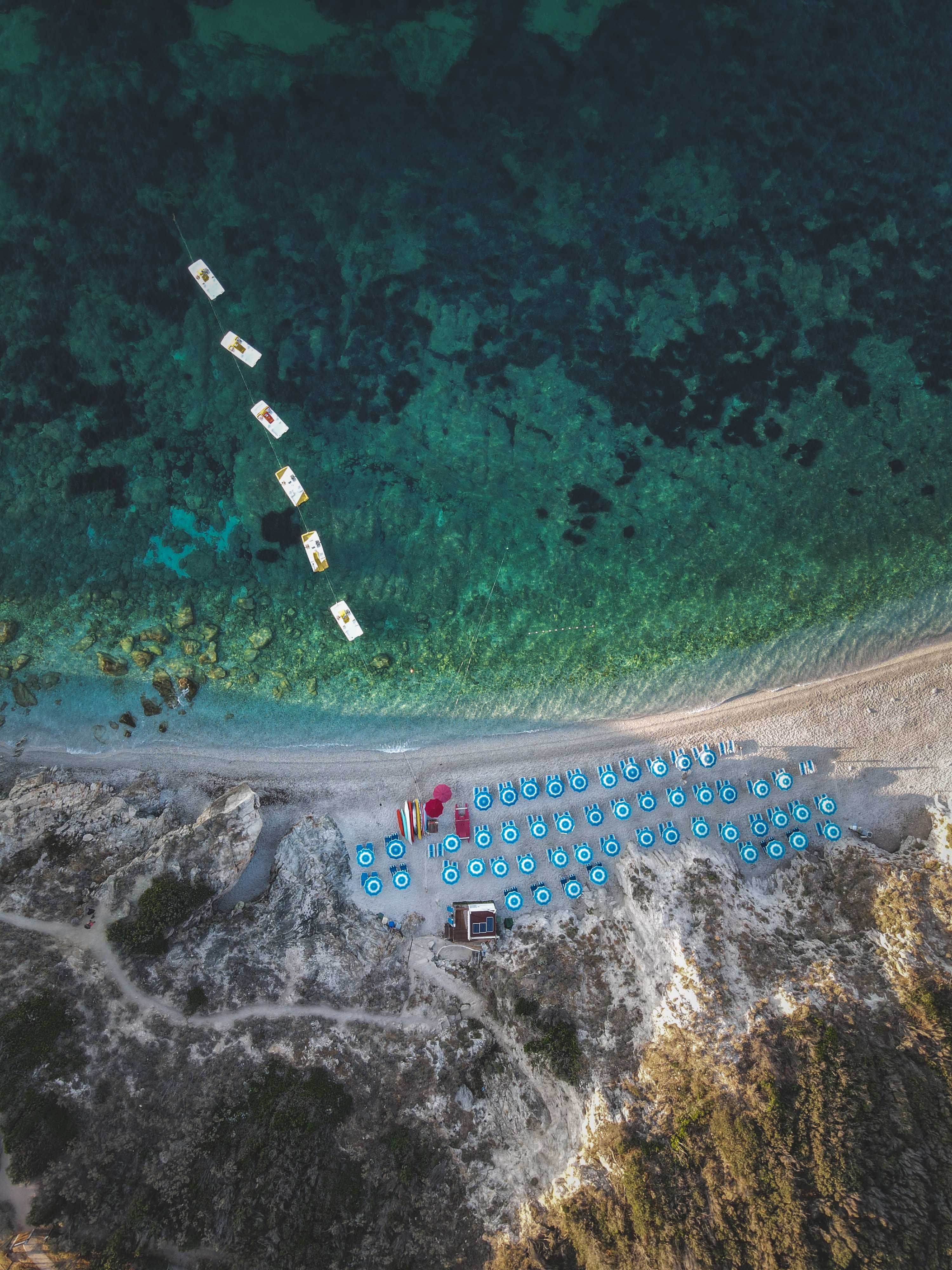 Birds Eye View of Beach Umbrellas on Shore · Free Stock Photo