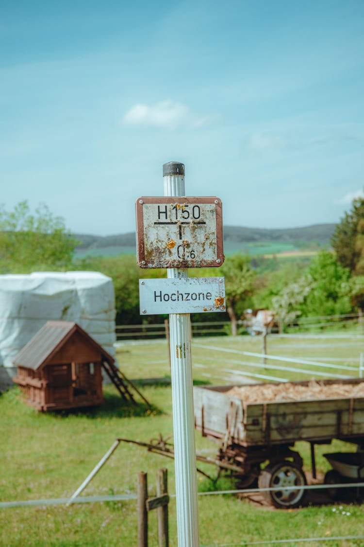 Post With Boards Near Farm