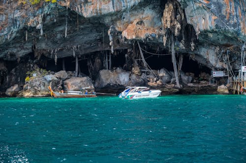 Motorboats Anchored by Cliff