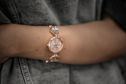 Golden Analogue Wristwatch on a Womans Arm