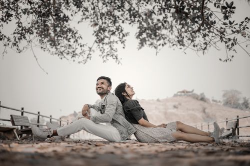 Free A couple relaxing and enjoying a serene autumn day outdoors, embracing nature's beauty. Stock Photo