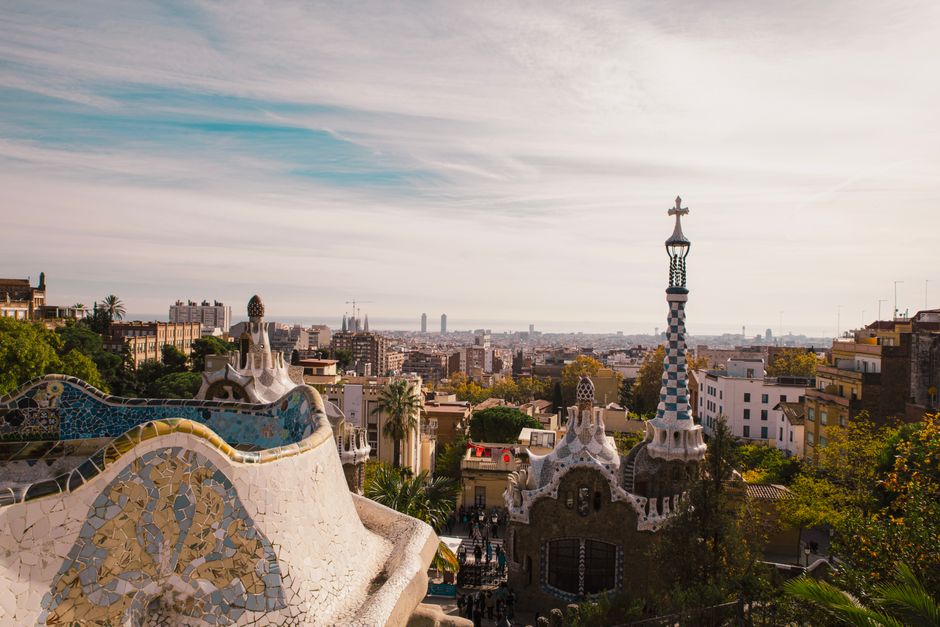 Captivating view of Barcelona city skyline from iconic Park Güell, featuring Gaudi architecture.