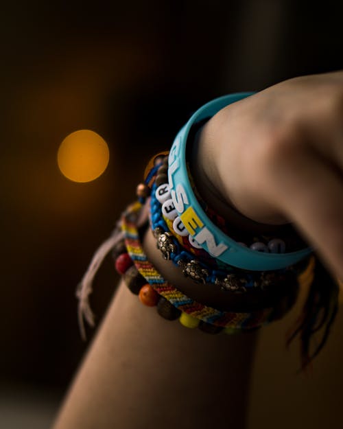Free Close-Up Photo of Person Wearing Assorted Bracelets Stock Photo