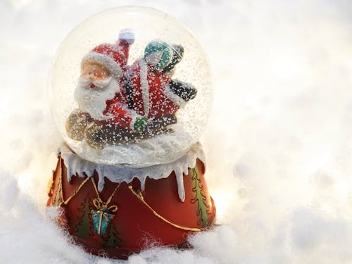 Close-up Photography Of Santa Claus Snow Globe