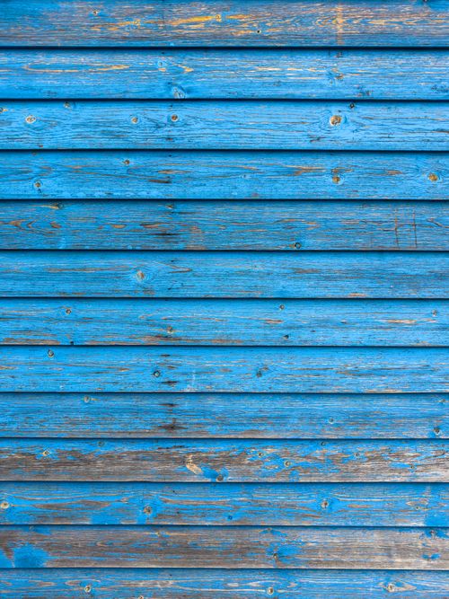 Free Close-up of a weathered blue wooden plank wall showing texture and peeling paint. Stock Photo