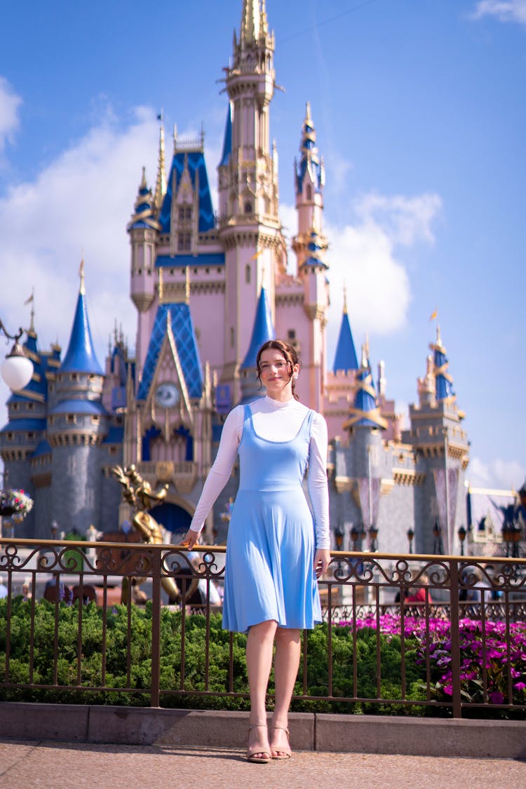 Woman Dressing Like Fairy Tale Princess Standing Against Castle In Disney World Resort