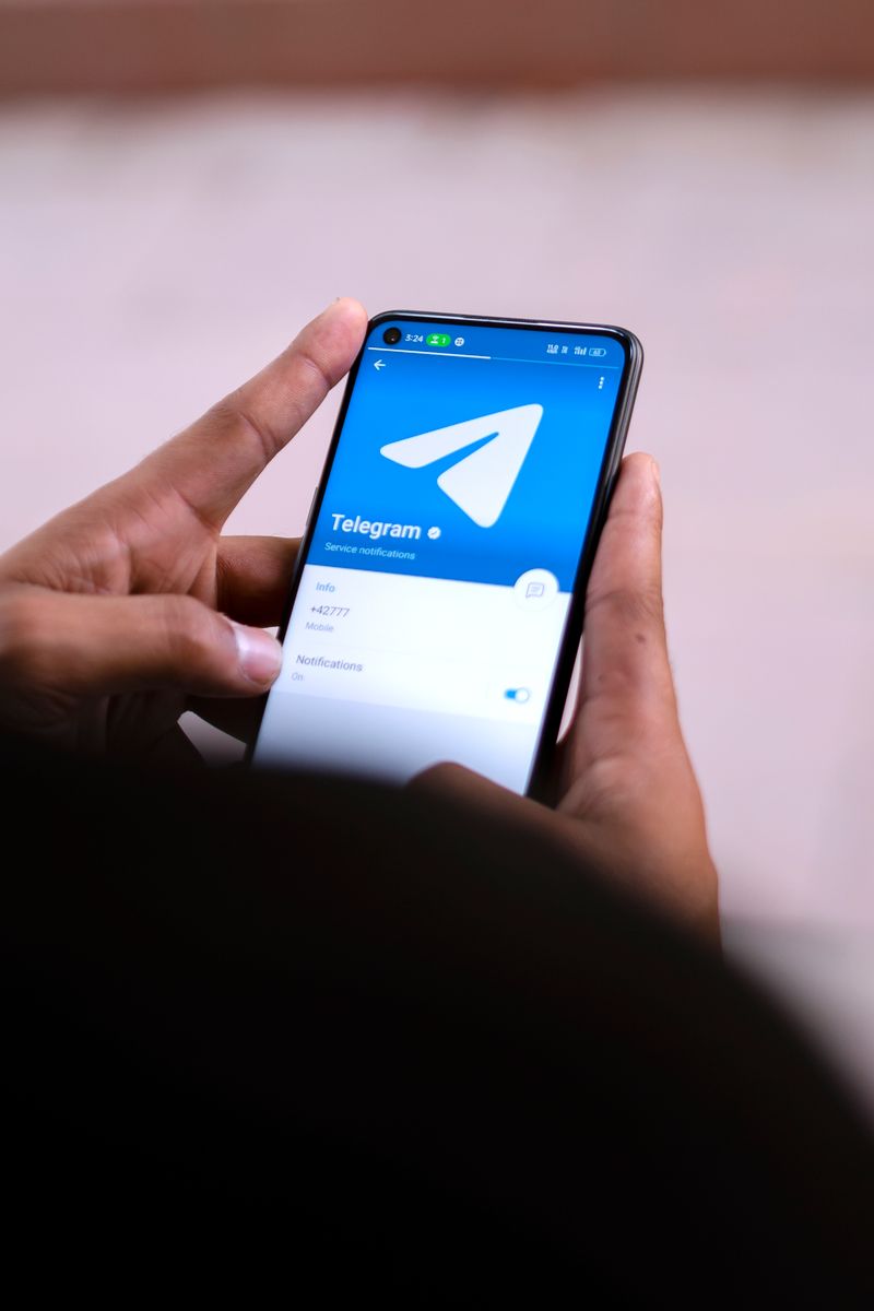 Hands holding a smartphone using a booking app on the screen