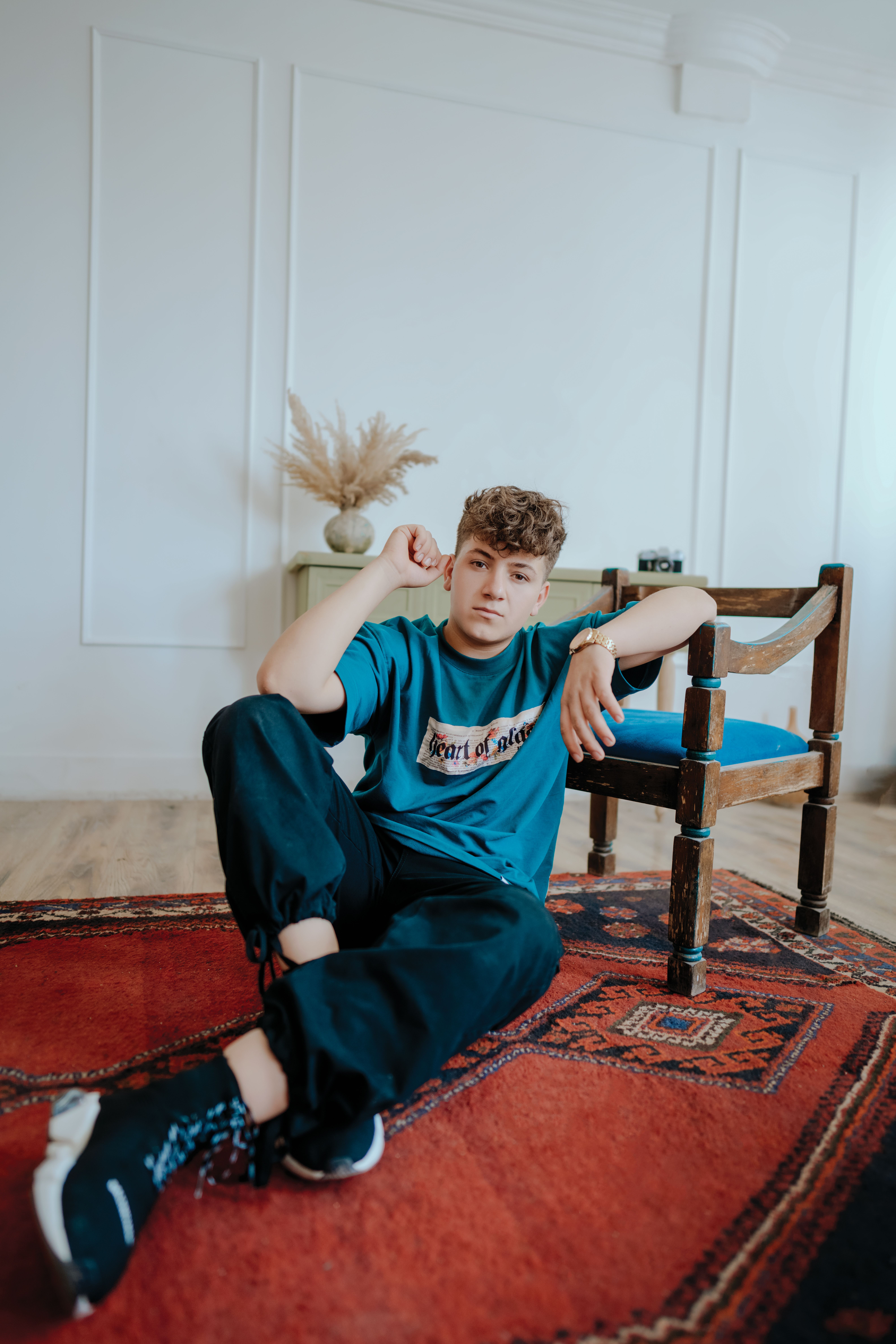 Young Man Sitting on Carpet · Free Stock Photo