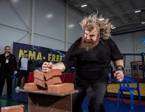 Strongman Breaking Bricks with Fist