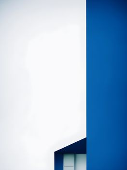 Abstract view of a blue and white building facade with a minimalist design and geometric patterns.
