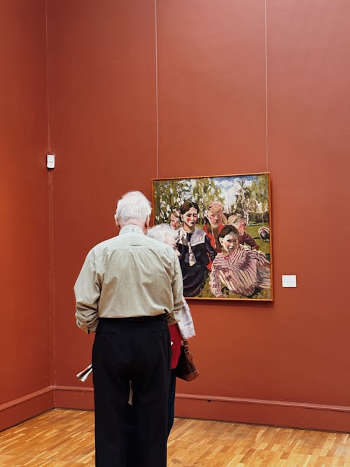 An Elderly Man Looking at Painting