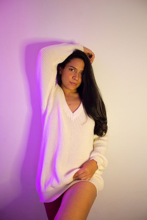 Woman Posing in Long White Sweater