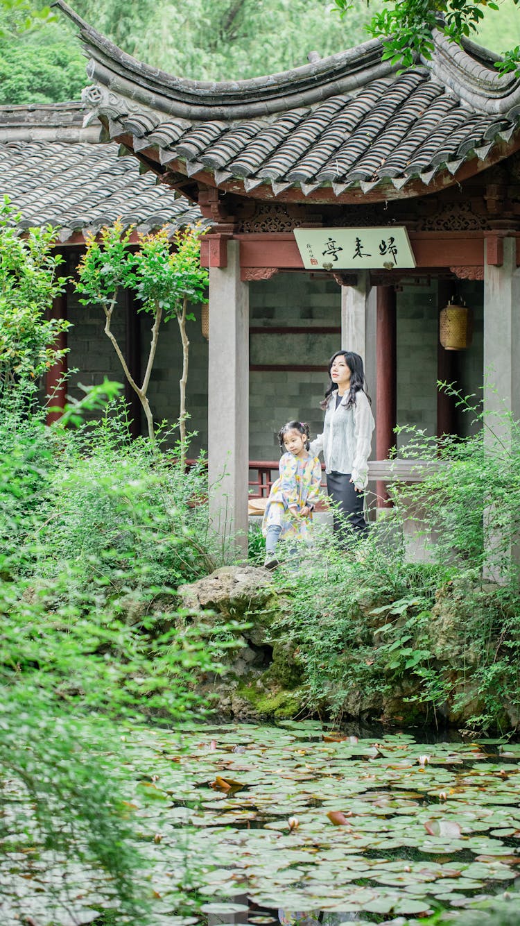 Mother And Daughter In Japanese Garden