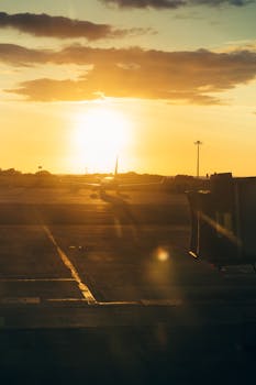 A stunning sunset view of an airplane on the runway at Kota Kinabalu Airport, Sabah, Malaysia.