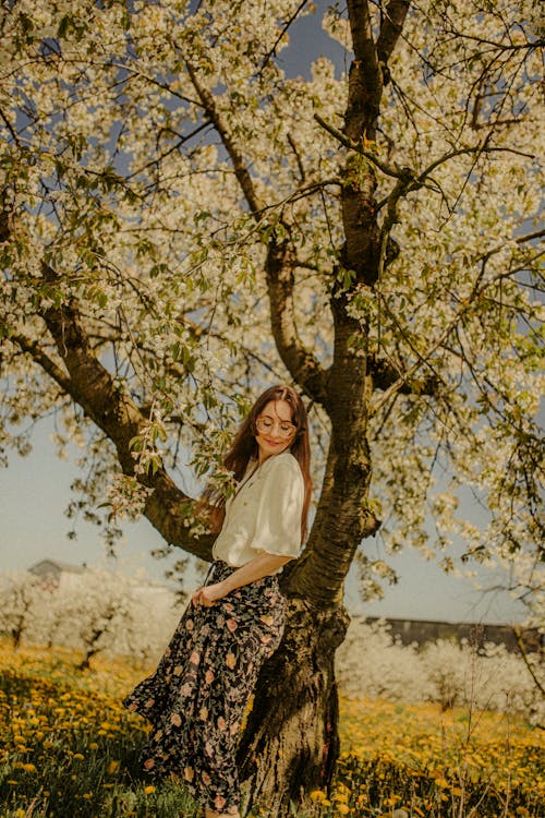 Woman Leaning on Blossoming Tree