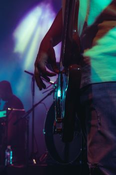 Close-up of a guitarist on stage, capturing the essence of live music performance.