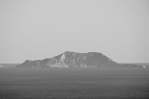 Rocky Island on Sea Shore in Black and White