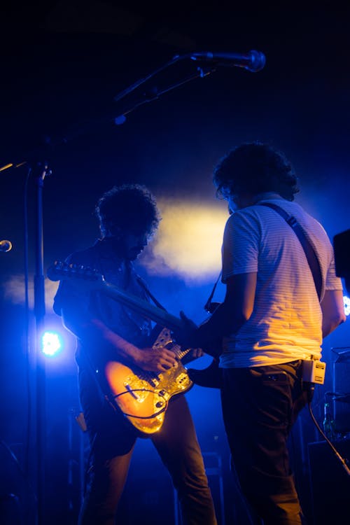Two Guitarists Playing on a Stage