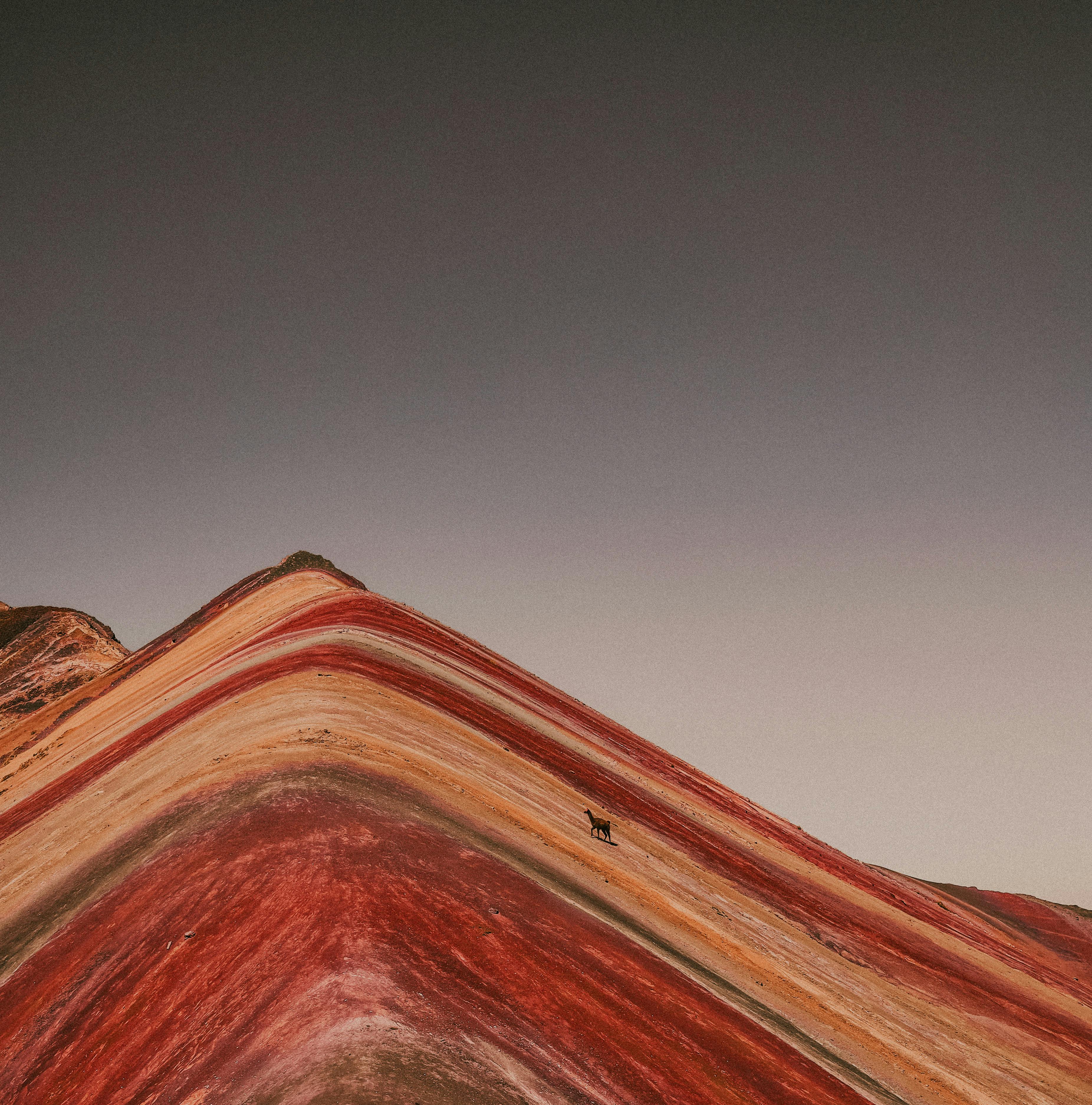 A mesmerizing aerial view of Cusco's iconic Rainbow Mountain with its vibrant natural stripes.