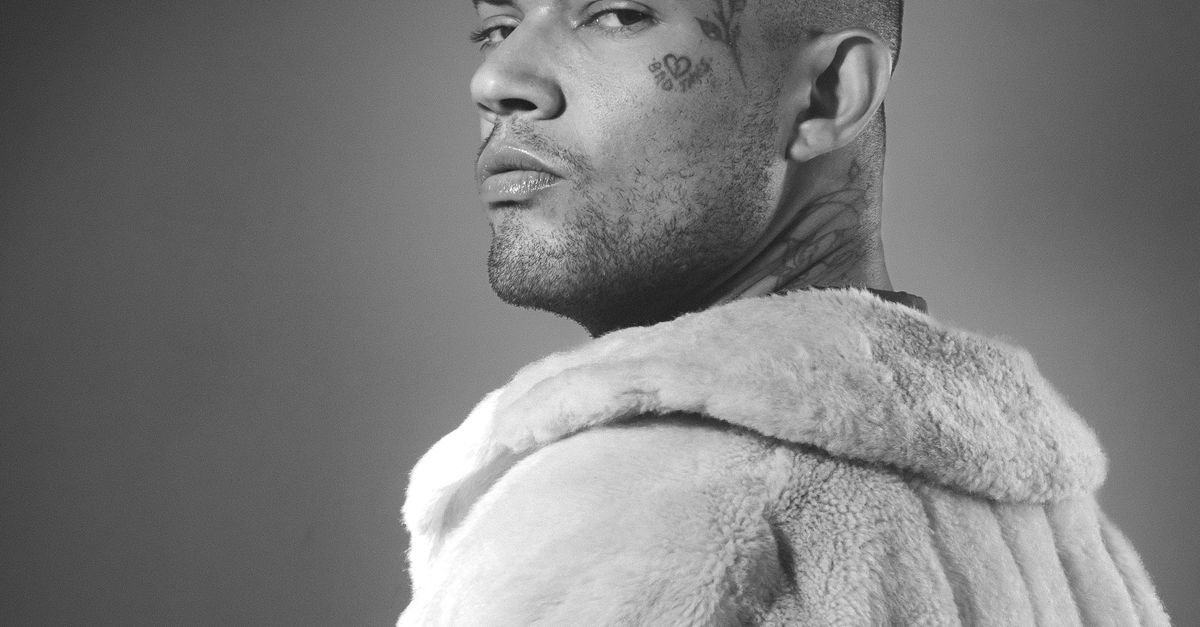 Black and White Photo of Man with Tattooed Face Wearing Fur Coat · Free