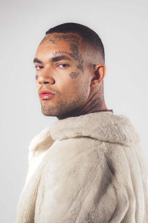 Man with Tattooed Face Wearing Fur Coat