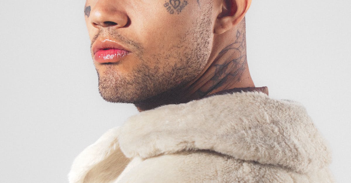 Man with Tattooed Face Wearing Fur Coat · Free Stock Photo