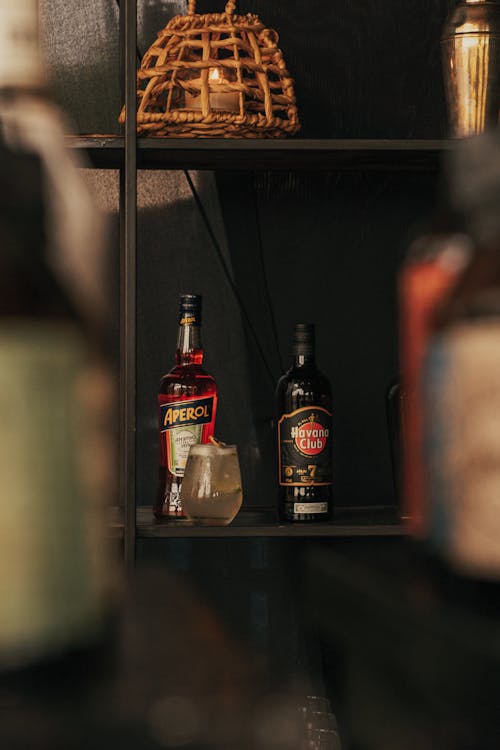 Alcoholic Drink and Bottles on a Shelf in a Bar 