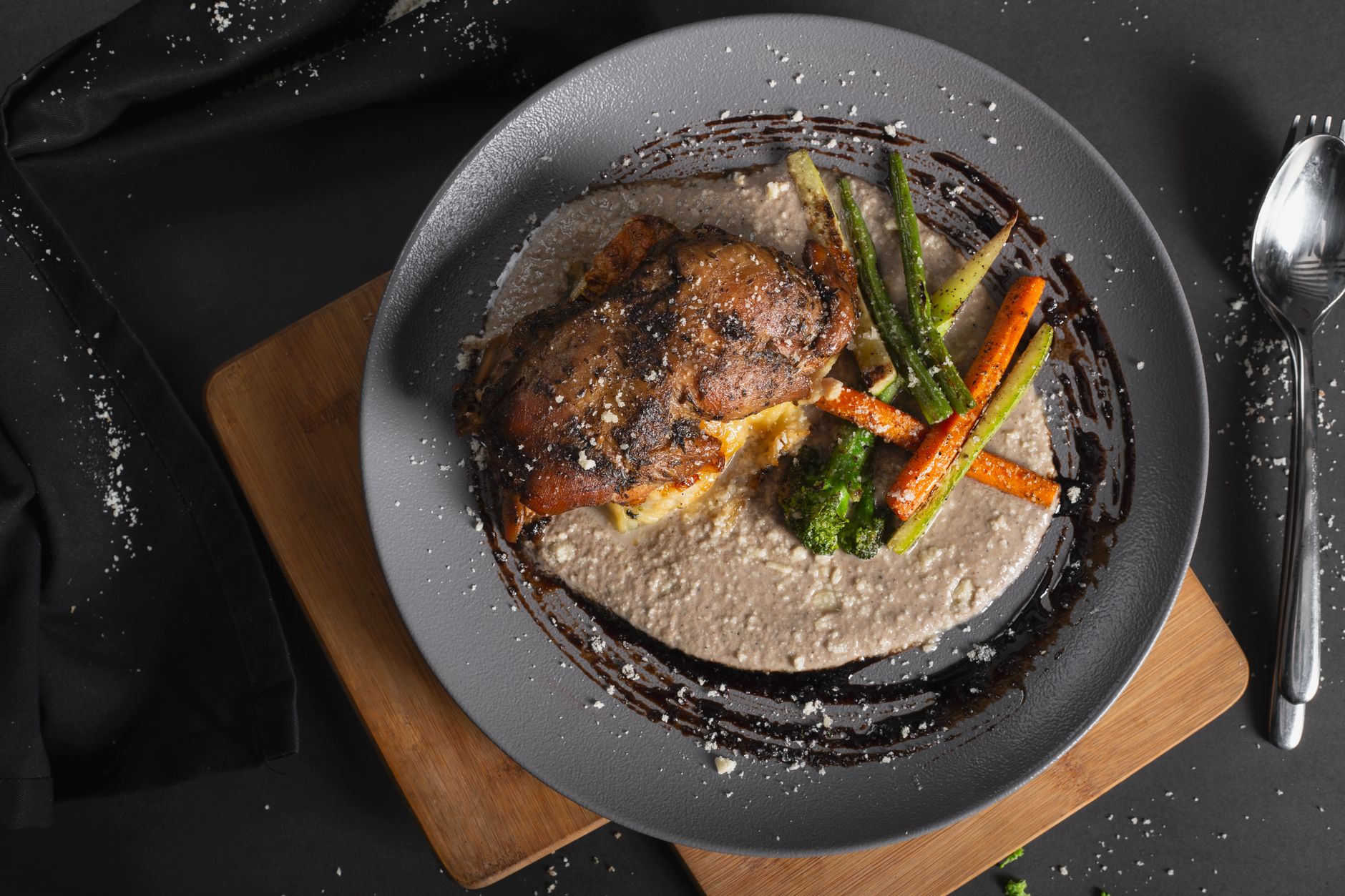 Velvety brown gravy in a serving bowl beside roasted chicken