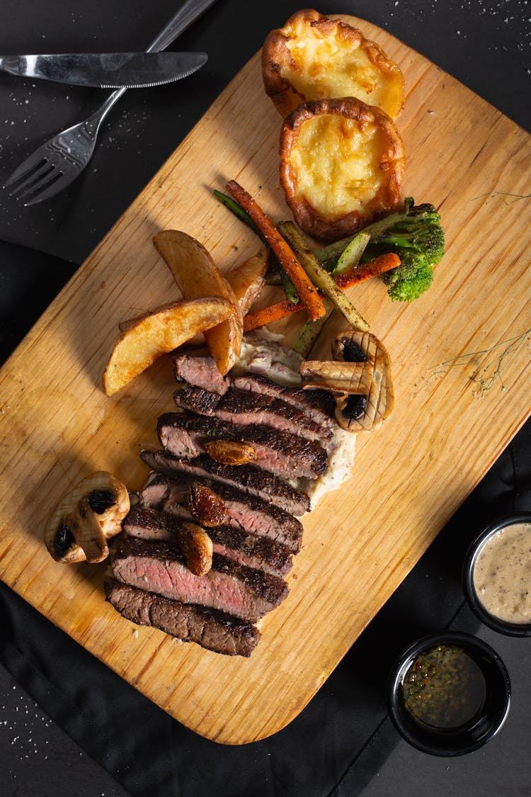 Steak And Vegetables On A Cutting Board