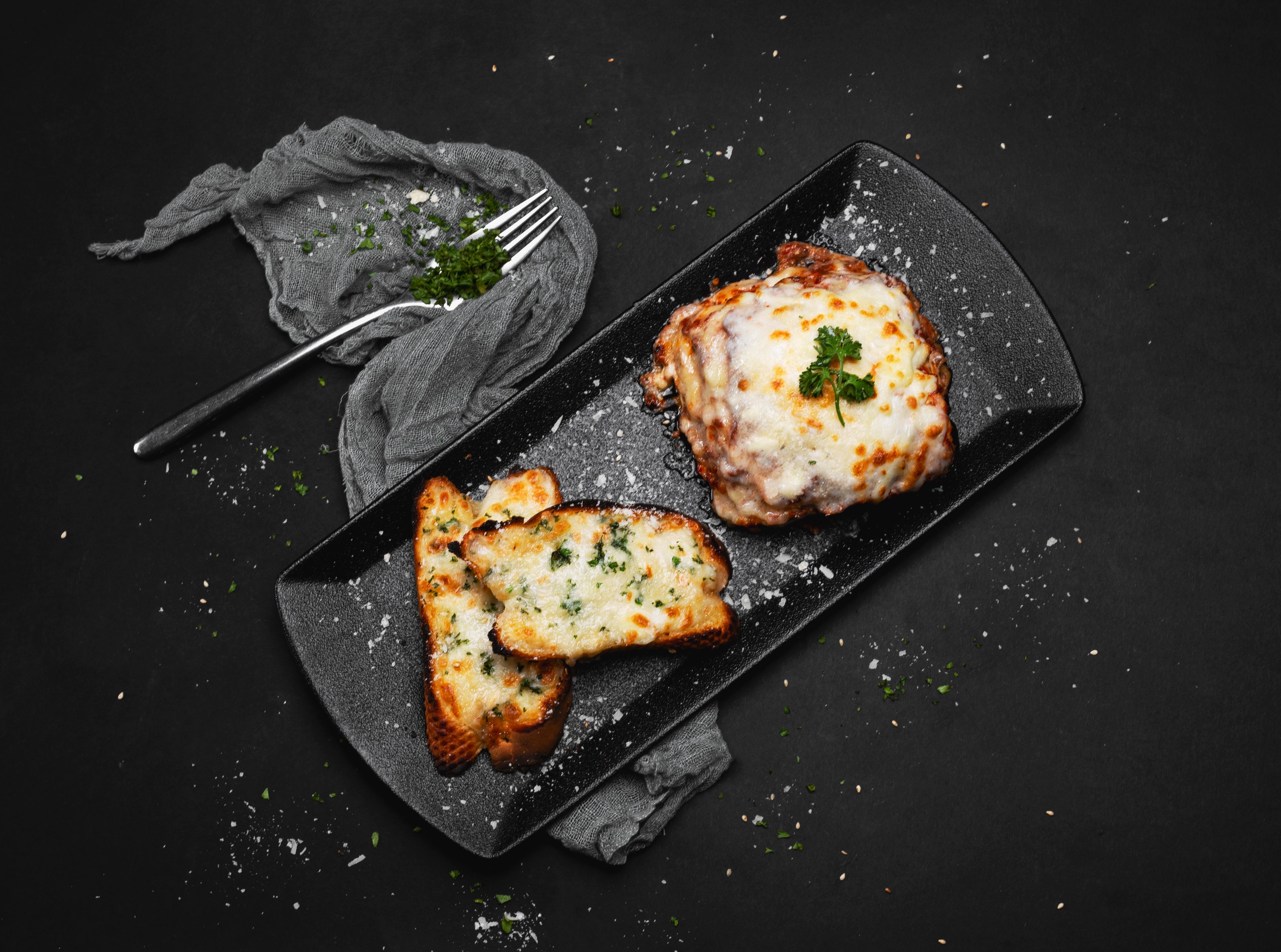 Baked dutch oven lasagna with golden cheese crust