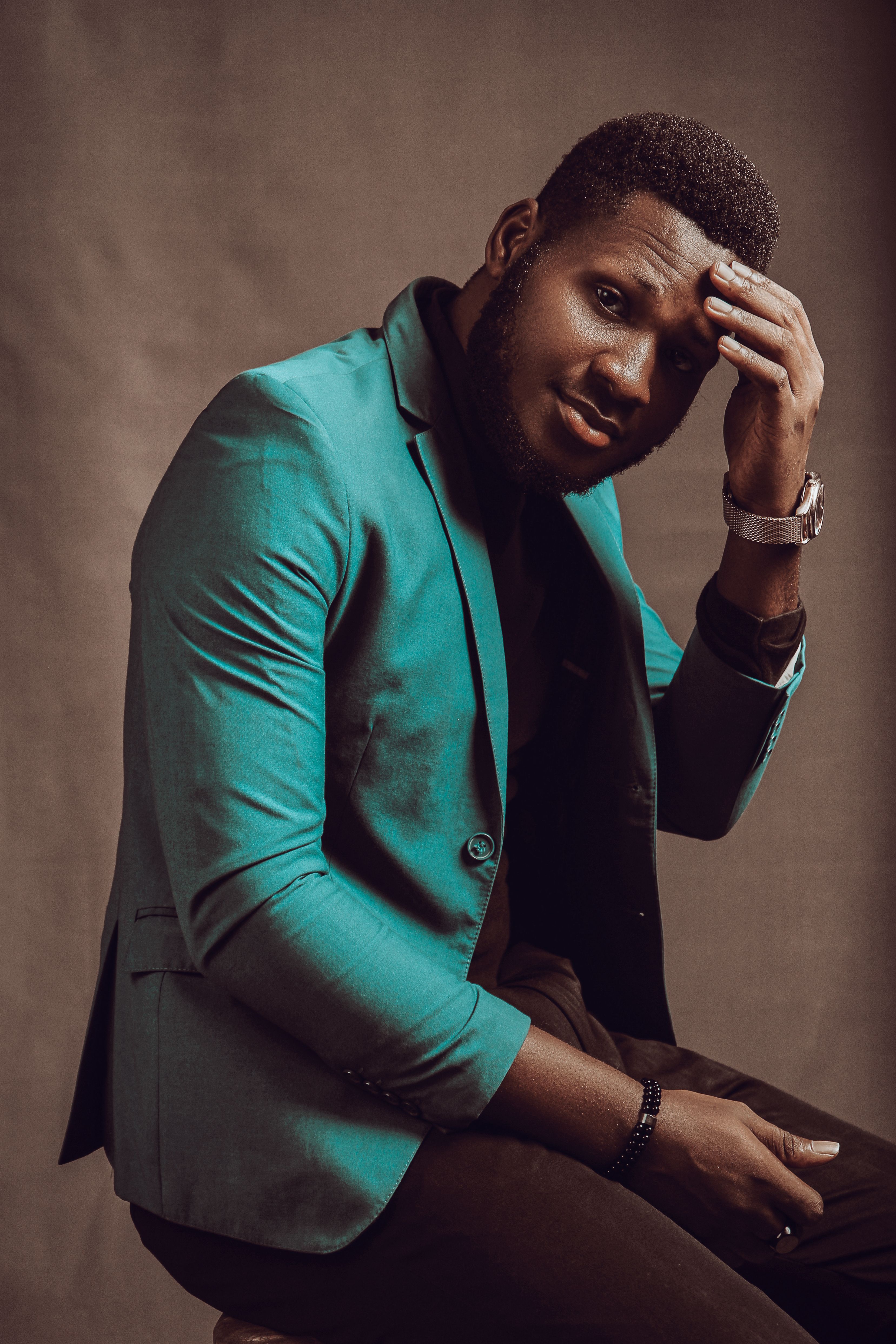 Stylish portrait of a handsome man in a green jacket during a studio shoot in Lagos.