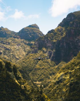 Aerial view of a drone navigating lush mountainous terrain in Madeira, Portugal.