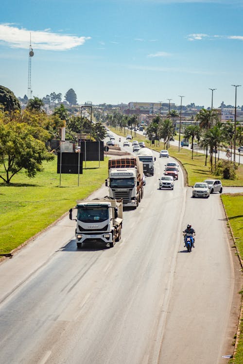 Trucks and Cars on Road in Town