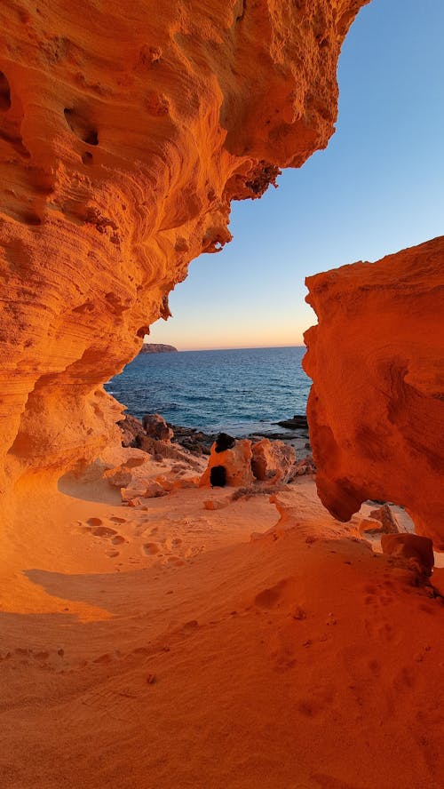 View of Eroded Sandstone Formations on a Beach at Sunset