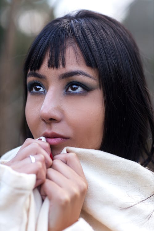 Young Brunette with Bangs and Dark Eye Makeup 